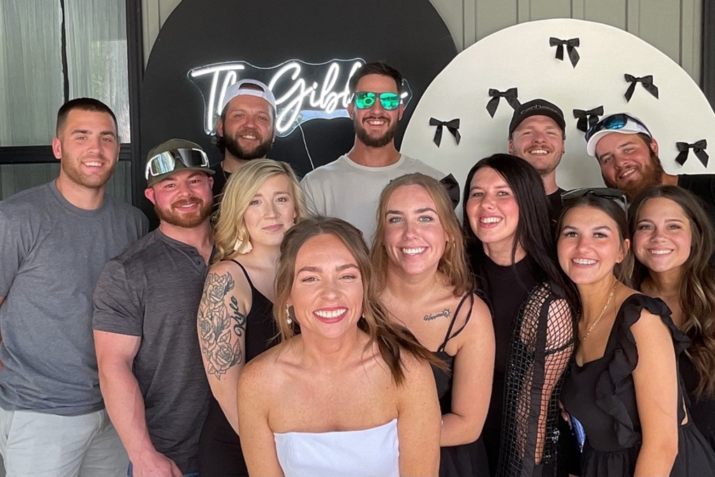 Friends laughing together at a photo booth during a wedding shower